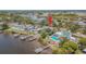 Waterfront home features multiple docks, lush landscaping, a swimming pool, and direct access to the bay at 739 Chesapeake Dr, Tarpon Springs, FL 34689