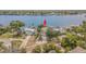 Waterfront home has a dock and mature landscaping with lush trees at 739 Chesapeake Dr, Tarpon Springs, FL 34689