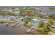 Waterfront home features multiple docks, lush landscaping, a swimming pool, and direct access to the bay at 739 Chesapeake Dr, Tarpon Springs, FL 34689