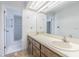 Traditional bathroom with dual sinks, and a tile surround walk-in shower at 739 Chesapeake Dr, Tarpon Springs, FL 34689