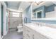 Renovated bathroom featuring a modern vanity, tiled shower, and accessible design elements at 739 Chesapeake Dr, Tarpon Springs, FL 34689