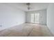Spacious bedroom ready for customization, features sliding glass doors to the backyard at 739 Chesapeake Dr, Tarpon Springs, FL 34689