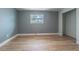 Light-filled bedroom boasts hardwood floors, a window for natural light, and ample space at 739 Chesapeake Dr, Tarpon Springs, FL 34689