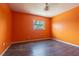 Empty bedroom with wood floors, orange walls, and natural light at 739 Chesapeake Dr, Tarpon Springs, FL 34689