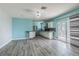 Open dining area with modern light fixture and slider doors to outside at 739 Chesapeake Dr, Tarpon Springs, FL 34689