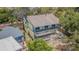 Two-story home with exterior balcony, offering a charming design and waterfront views from multiple levels at 739 Chesapeake Dr, Tarpon Springs, FL 34689