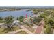 Waterfront home featuring a private dock, scenic views, and lush landscaping in a desirable neighborhood at 739 Chesapeake Dr, Tarpon Springs, FL 34689