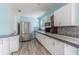 Updated kitchen with stainless steel appliances, white cabinets, and stylish backsplash at 739 Chesapeake Dr, Tarpon Springs, FL 34689