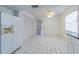White-tiled eat-in kitchen with pantry, window, drop-in lighting and side-by-side refrigerator at 739 Chesapeake Dr, Tarpon Springs, FL 34689
