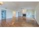 Spacious living room with hardwood floors, a cozy fireplace, and built-in shelving at 739 Chesapeake Dr, Tarpon Springs, FL 34689