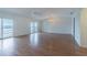 Open living room with hardwood floors, sliding glass doors to balcony and waterfront view at 739 Chesapeake Dr, Tarpon Springs, FL 34689