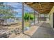 Covered patio with views of the backyard, water access and wooden deck area at 739 Chesapeake Dr, Tarpon Springs, FL 34689