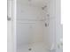 Walk-in shower features white tile and grab bar at 739 Chesapeake Dr, Tarpon Springs, FL 34689