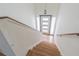 A bright foyer leads to this home, with hardwood stairs, and modern door at 739 Chesapeake Dr, Tarpon Springs, FL 34689