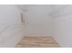 Functional walk-in closet with ample shelving and laminate wood flooring at 739 Chesapeake Dr, Tarpon Springs, FL 34689