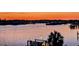 Beautiful waterfront view at sunset, featuring boat docks and peaceful water reflecting the colorful sky at 739 Chesapeake Dr, Tarpon Springs, FL 34689