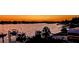 Beautiful waterfront view at sunset, featuring boat docks and mature shade trees across the water at 739 Chesapeake Dr, Tarpon Springs, FL 34689