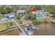 Aerial view of waterfront home with dock and boat lift on a sunny day at 739 Chesapeake Dr, Tarpon Springs, FL 34689