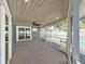 Inviting screened back porch with tongue and groove ceiling, overlooking the pool area at 800 Embassy Rd, Largo, FL 33771