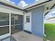 Inviting screened back porch with exterior door to the backyard and pool at 800 Embassy Rd, Largo, FL 33771