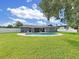 Well-maintained backyard featuring a sparkling pool, green lawn and fenced perimeter at 800 Embassy Rd, Largo, FL 33771