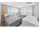 Cozy bedroom with a neutral color palette, featuring a closet with built-in shelves and drawers at 800 Embassy Rd, Largo, FL 33771