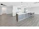 An open floor plan featuring white cabinets and a large center island with seating at 800 Embassy Rd, Largo, FL 33771
