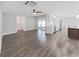 Open-concept living room with hardwood floors, connecting seamlessly to the kitchen and dining area at 800 Embassy Rd, Largo, FL 33771