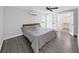 Airy primary bedroom with hardwood floors, a ceiling fan, and an ensuite bathroom and walk in closet at 800 Embassy Rd, Largo, FL 33771