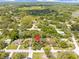 Expansive aerial view showcasing the home's location within a lush, tree-filled neighborhood at 8268 Garrison St, Spring Hill, FL 34606