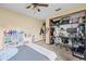 Bedroom features a ceiling fan, carpet floors, and a desk at 8268 Garrison St, Spring Hill, FL 34606