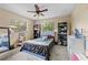 Bedroom features a ceiling fan, carpet floors, and ample natural light at 8268 Garrison St, Spring Hill, FL 34606