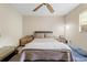 Bedroom features a ceiling fan, carpet floors, and a desk at 8268 Garrison St, Spring Hill, FL 34606