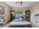 Bedroom features a ceiling fan, carpet floors, and ample natural light at 8268 Garrison St, Spring Hill, FL 34606