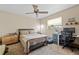 Bedroom features a ceiling fan, carpet floors, and a desk at 8268 Garrison St, Spring Hill, FL 34606