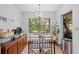 Cozy dining area featuring a wood table, chairs, and a large window with a green view at 8268 Garrison St, Spring Hill, FL 34606