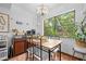 Dining area with a wood table, black chairs, and a window view to outside greenery at 8268 Garrison St, Spring Hill, FL 34606