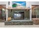 Close up of the fireplace in the living room with a stone hearth and a TV above it at 8268 Garrison St, Spring Hill, FL 34606