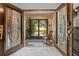 Inviting foyer with decorative glass doors and views of the landscaped front yard at 8268 Garrison St, Spring Hill, FL 34606