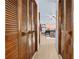 Hallway view of the bright main bedroom featuring light wood floors and lots of natural light at 8268 Garrison St, Spring Hill, FL 34606