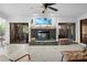 Living room fireplace with stone surround and raised hearth and a TV above the fireplace at 8268 Garrison St, Spring Hill, FL 34606