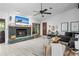 Sun-drenched living room with stone fireplace and wood flooring at 8268 Garrison St, Spring Hill, FL 34606