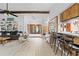 Spacious living room with a beam ceiling, gray sofa, built-in shelves and an open entrance to a dining area at 8268 Garrison St, Spring Hill, FL 34606