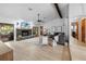 Open living room with a stone fireplace, modern furniture, and light wood flooring at 8268 Garrison St, Spring Hill, FL 34606