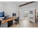 Office space featuring a wooden desk, a view to the kitchen, and a comfortable work environment at 8268 Garrison St, Spring Hill, FL 34606