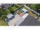 Aerial view showing a blue shed in the backyard near patio area, lawn, and palm trees at 8310 Pat Blvd, Tampa, FL 33615