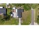 This aerial view showcases the property's layout, including the house, driveway, and spacious, well-maintained lawn at 8310 Pat Blvd, Tampa, FL 33615