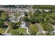 Aerial view showcasing the property layout with a blue shed, manicured lawns, and surrounding neighborhood at 8310 Pat Blvd, Tampa, FL 33615