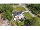 Aerial view featuring property with blue shed, patio, mature trees and a well-maintained lawn at 8310 Pat Blvd, Tampa, FL 33615
