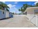 Spacious backyard featuring a shed and ample paved area, ideal for outdoor activities and storage at 8310 Pat Blvd, Tampa, FL 33615